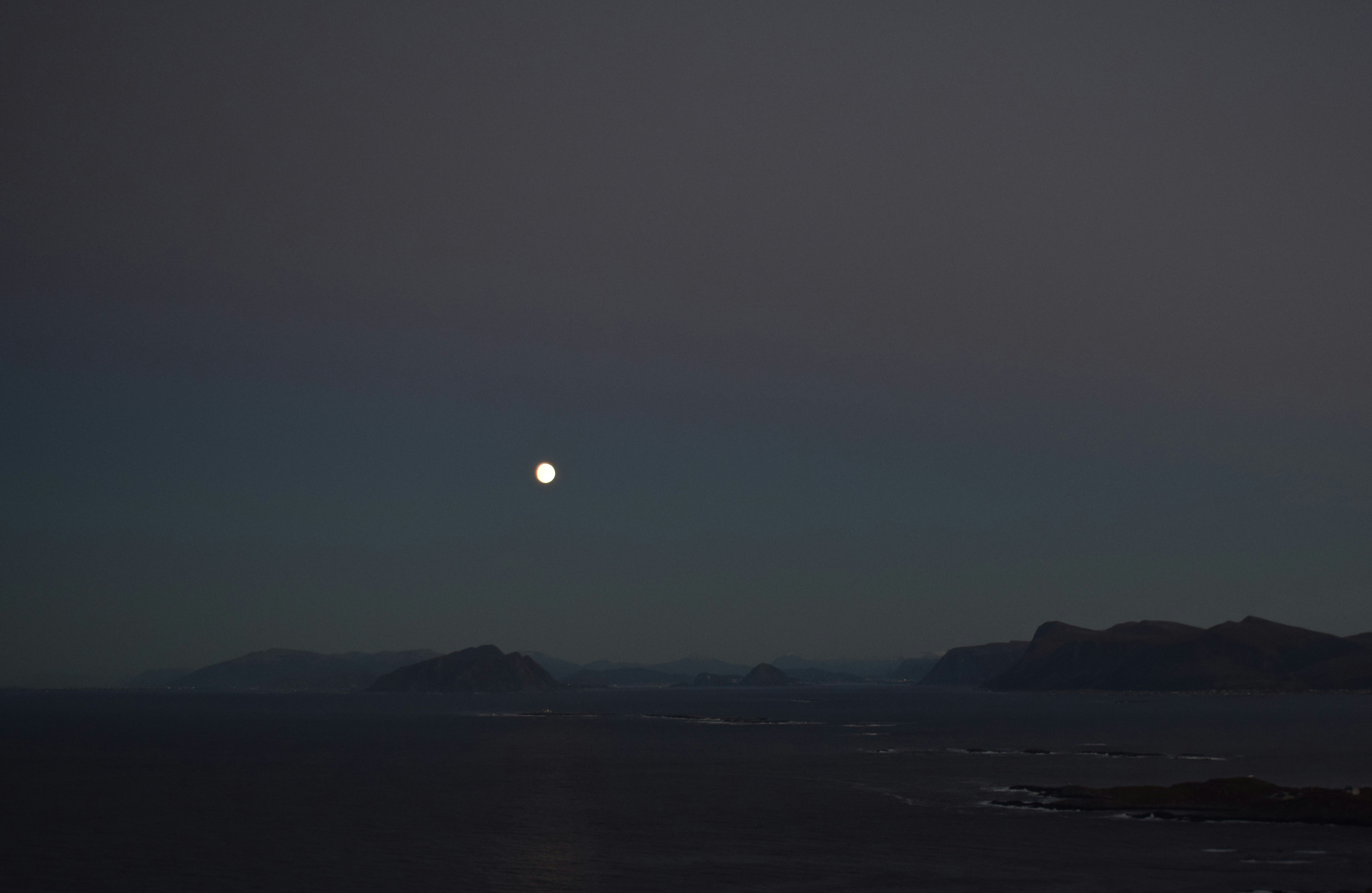 silhouette of mountain during night time